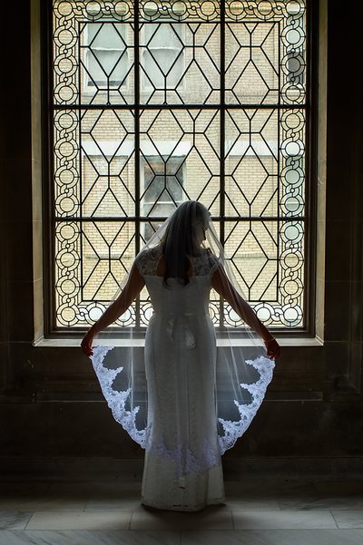 Beautiful Wedding Veil for this San Francisco City Hall Bride as she stand in front of this ornate window