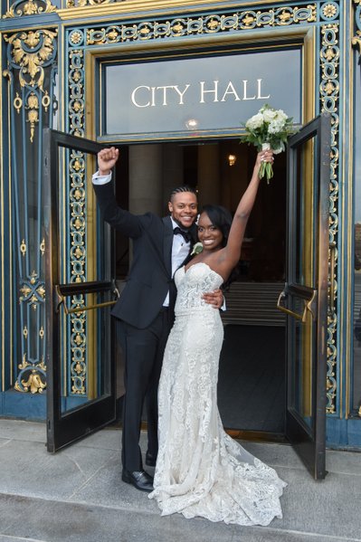 San Francisco couple celebrating at the City Hall Entrance