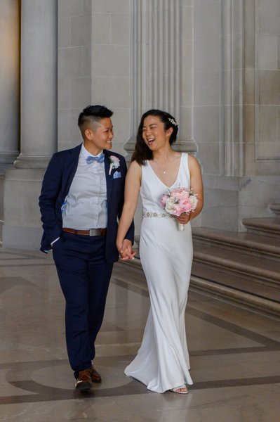 Bride and bride walk at City Hall