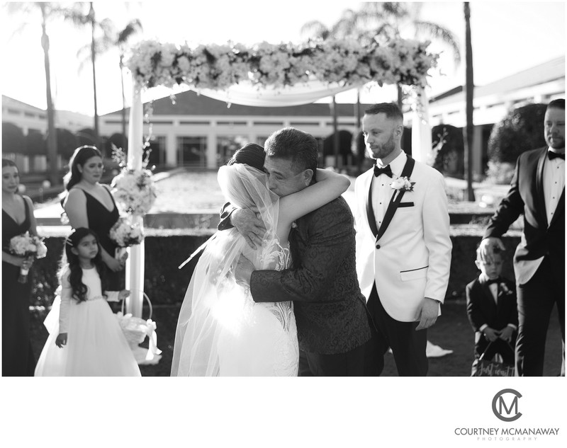 The Bride is Hugged by Her Father at the Nixon Library