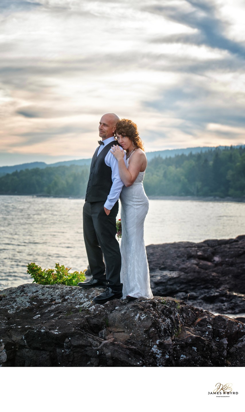 Wedding couple on rocky beach