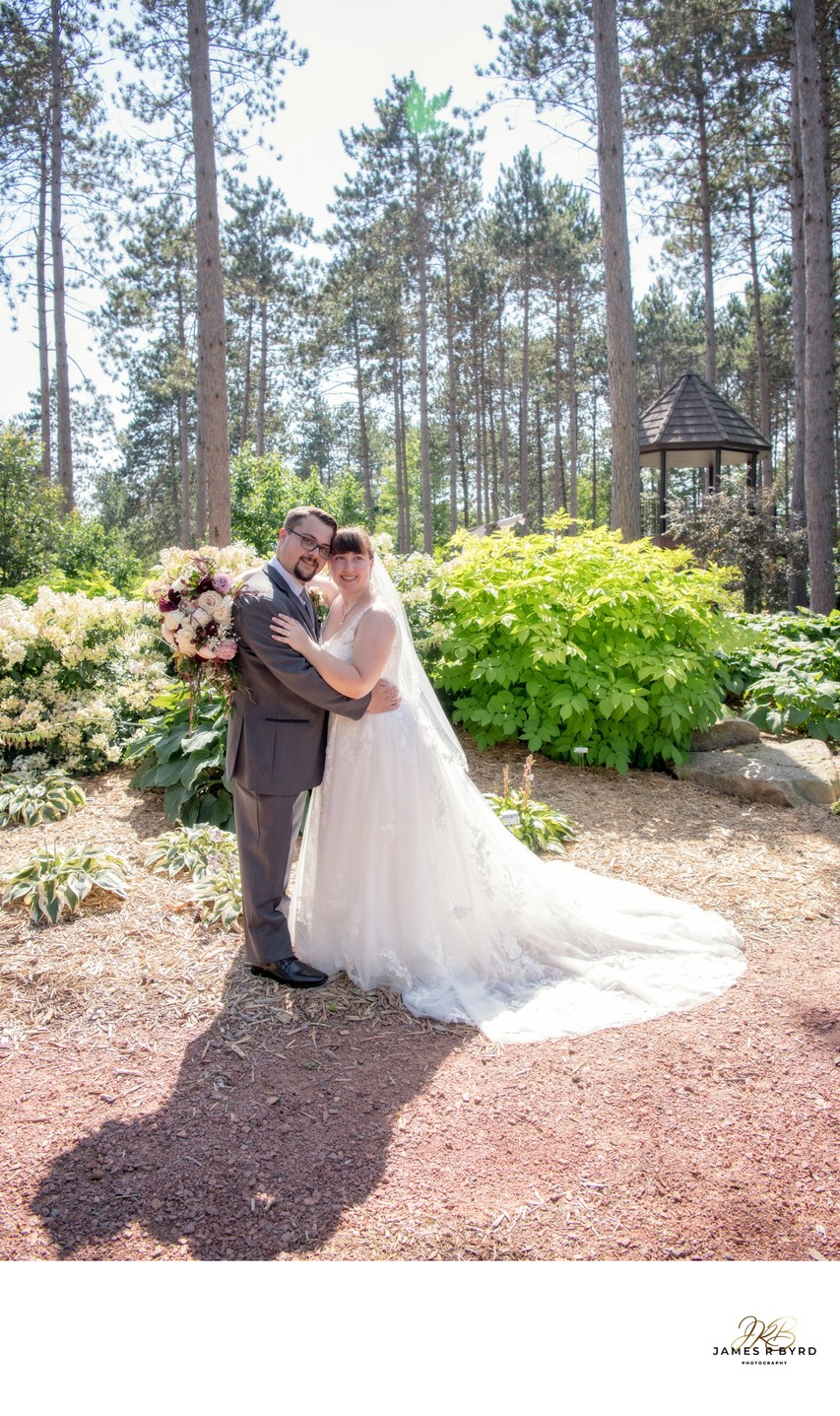 Wedding couple strolls through Monk Gardens.