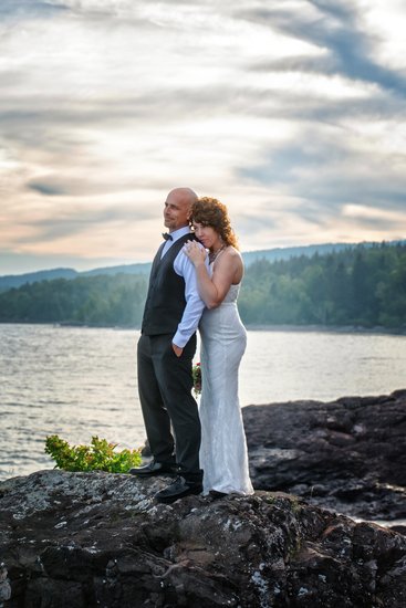 Wedding couple on rocky beach