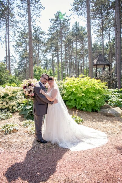 Wedding couple strolls through Monk Gardens.