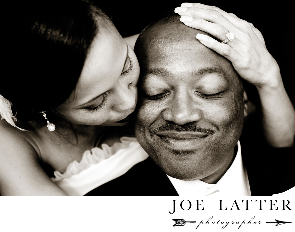 Beautiful black and white wedding image of African American man and his Asian bride.