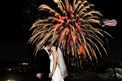 Amazing image of bride and groom kissing on Fourth 4thof July with fireworks at DragonRidge Golf Club in Henderson, Nevada.