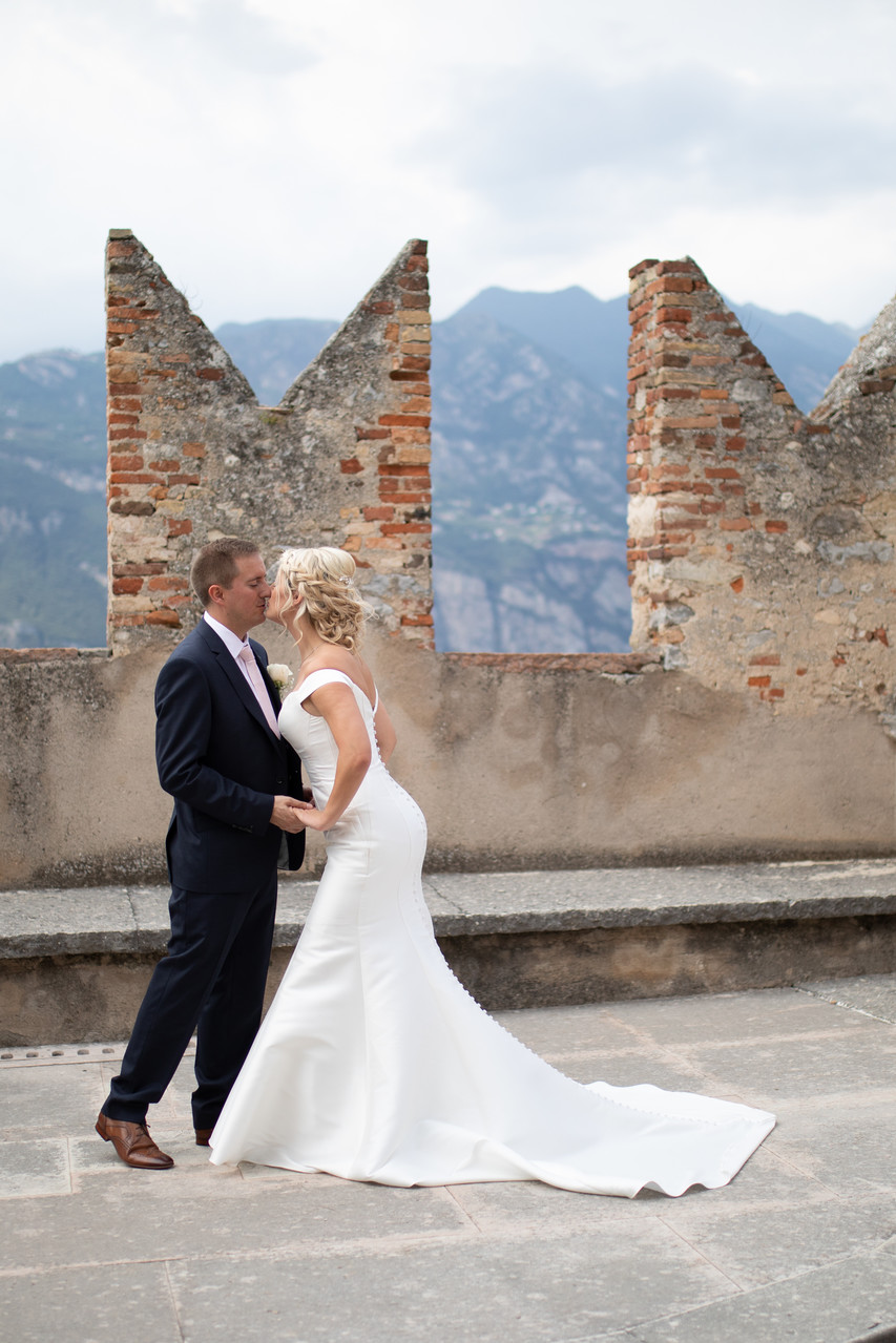 Claire and Adam kissing in Malcesine Castle, Lake Garda