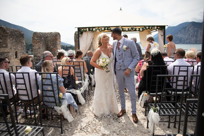 Kissing down the aisle, Malcesine Castle, Italy