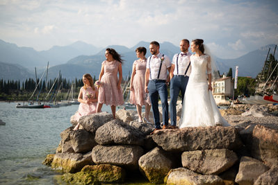 Bridal party on the rocks, Lake Garda, Italy.