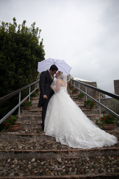 Fanciful weddings in Malcesine Castle in the rain.