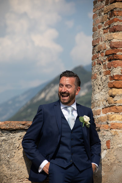 Laughing groom, Malcesine Castle, Lake Garda, Italy.