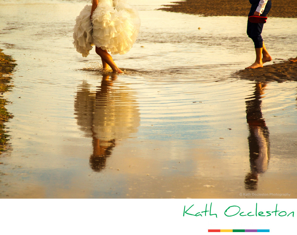 Reflections of bride & groom in the sea
