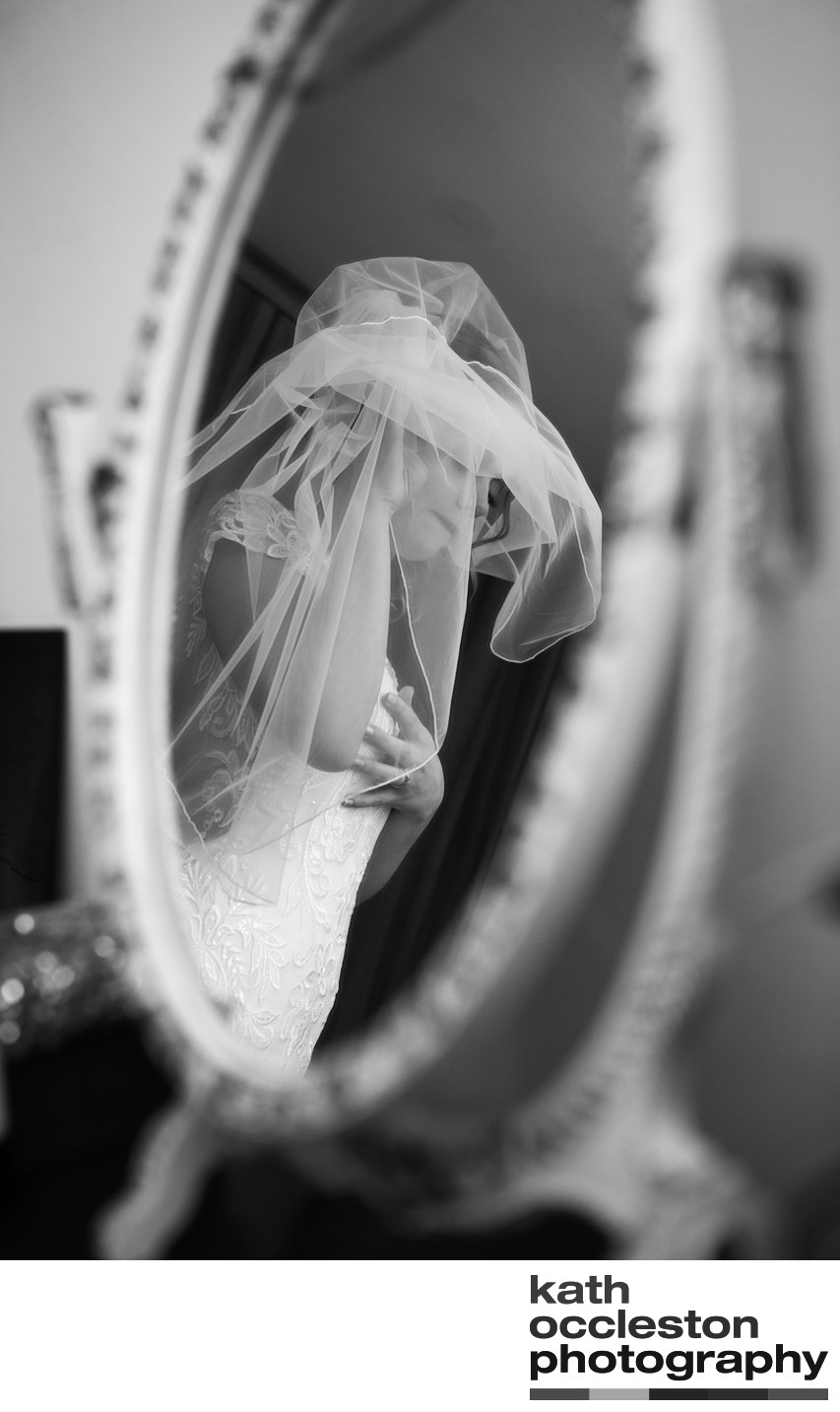 Bride getting ready in the mirror