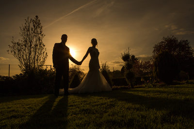 Couple silhouetted against the setting sun