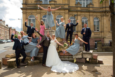 Fun wedding group photo on the Liverpool Suitcases