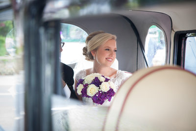 Bride in the wedding car outside St Annes Parish Church