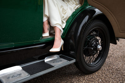 Bride stepping out of the wedding car