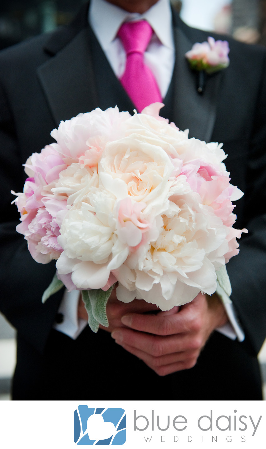 Groom holding white pink peony bridal flower bouquet