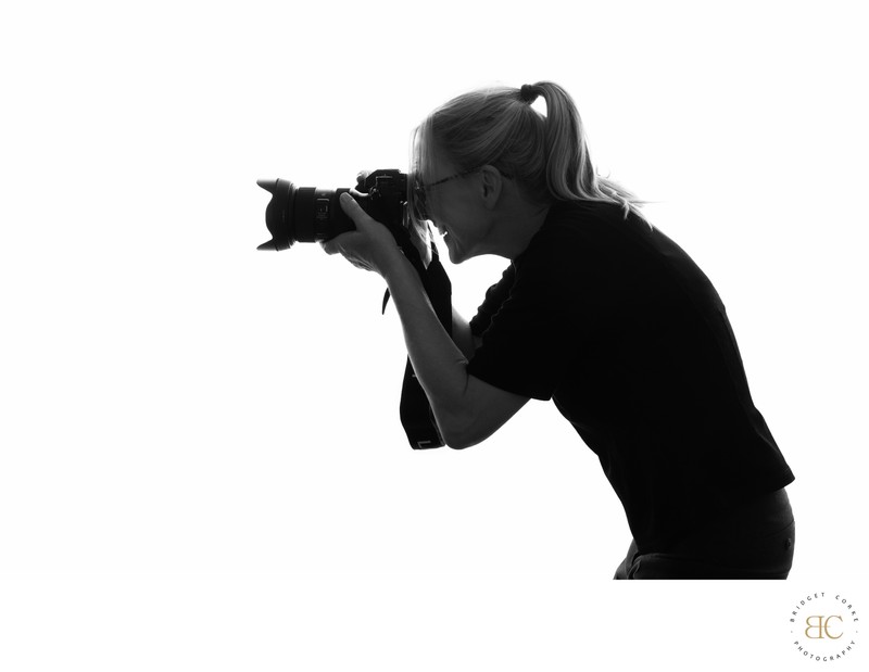Bridget Corke holding her camera in studio
