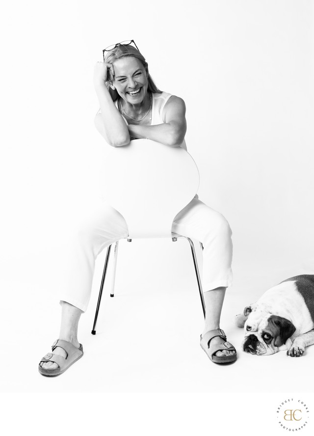Portrait of Bridget Corke with her bulldog Baby Yoda