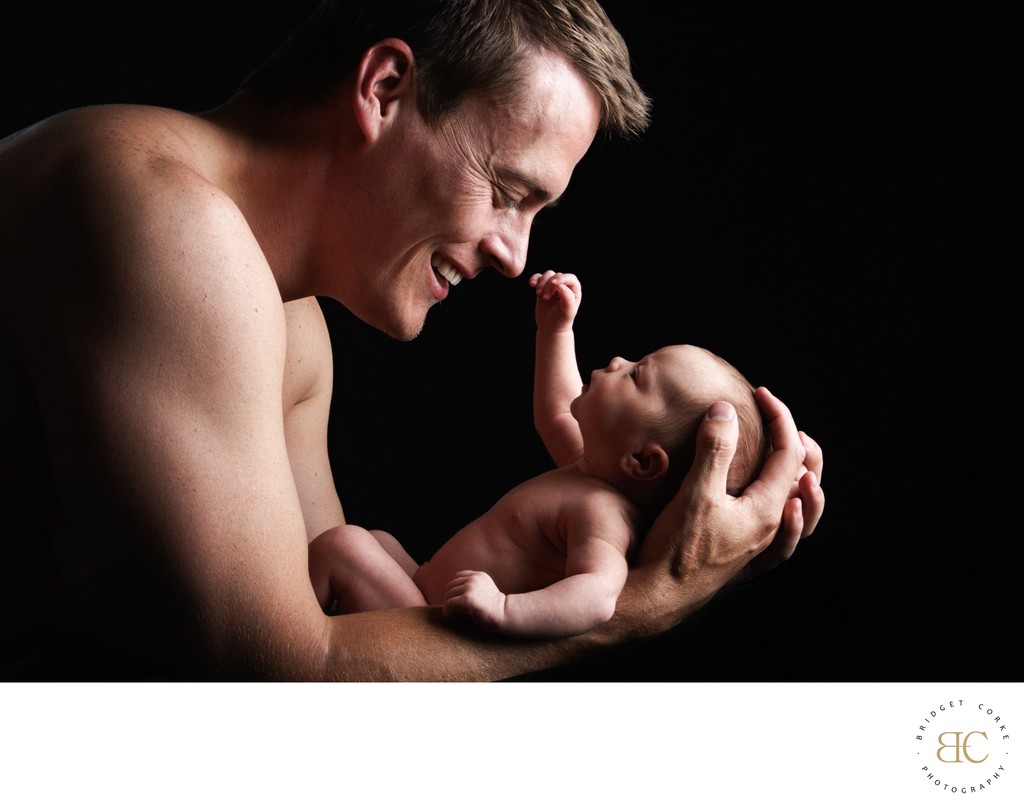 Newborn Staring At Dad