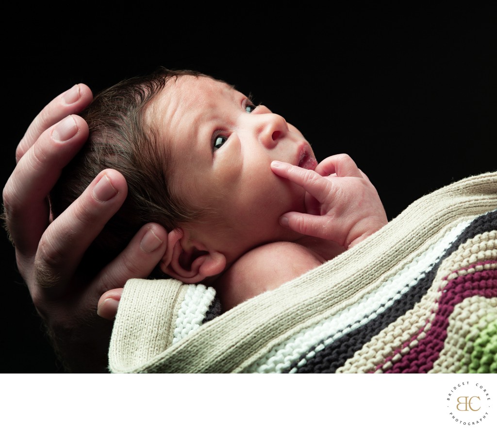 Newborn Wrapped In Knitted Blanket