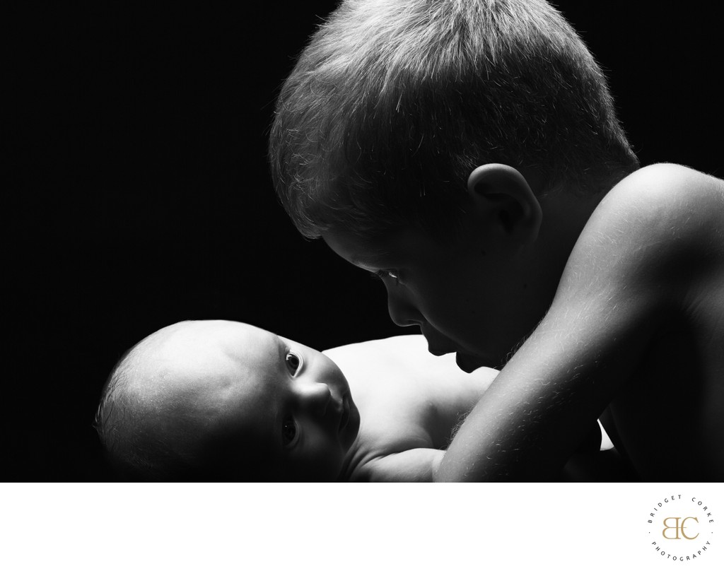 Boy Staring Newborn Brother