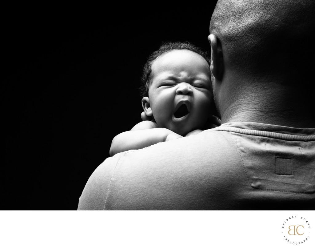 Newborn Yawning Over Dad Shoulder