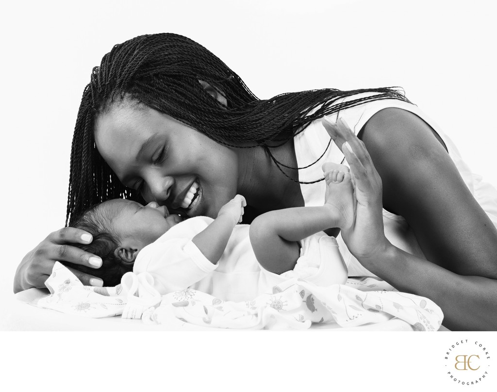 Newborn And Mom Wearing All White Wardrobe