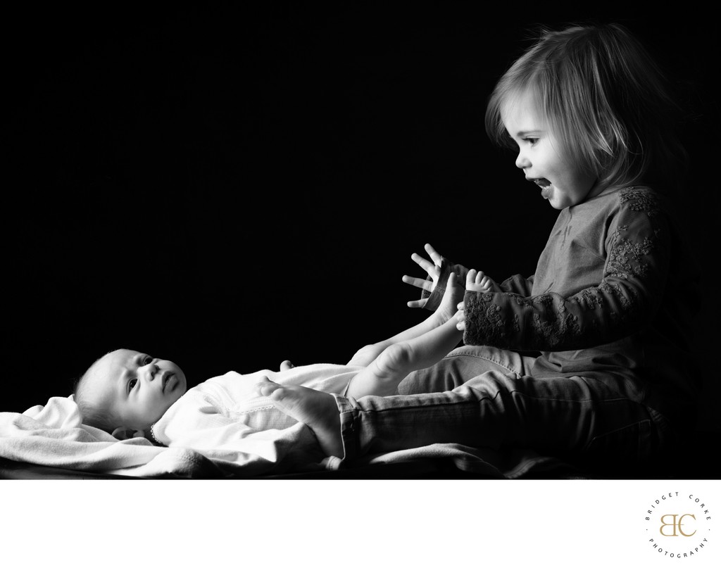 Excited Toddler WIth Newborn Sister