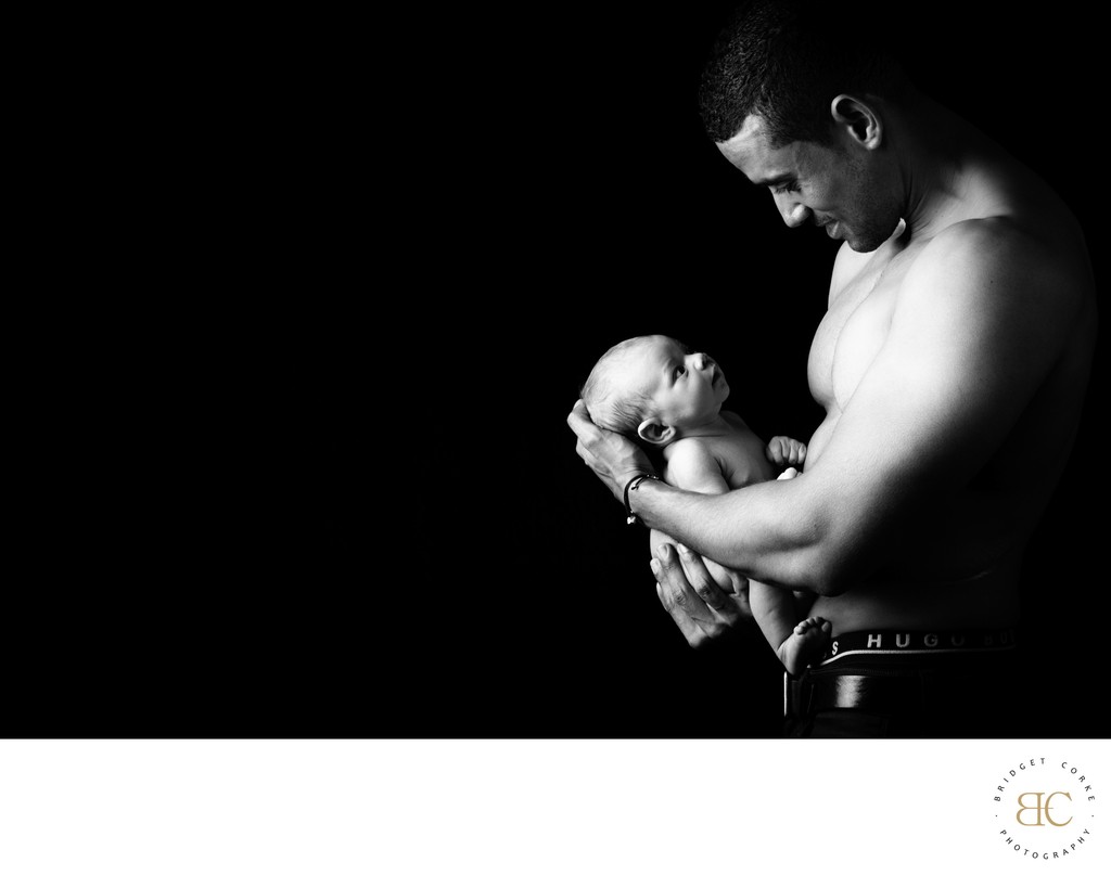 Shirtless Father Holding Newborn