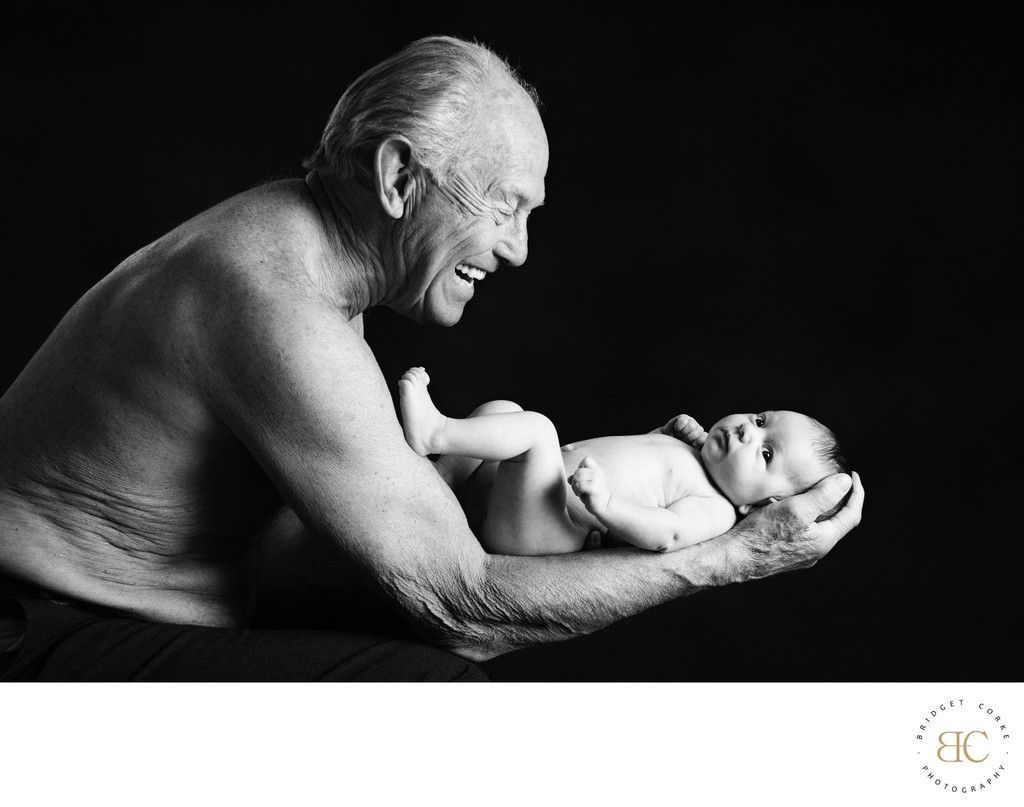 Grandpa Holding Newborn Granddaughter