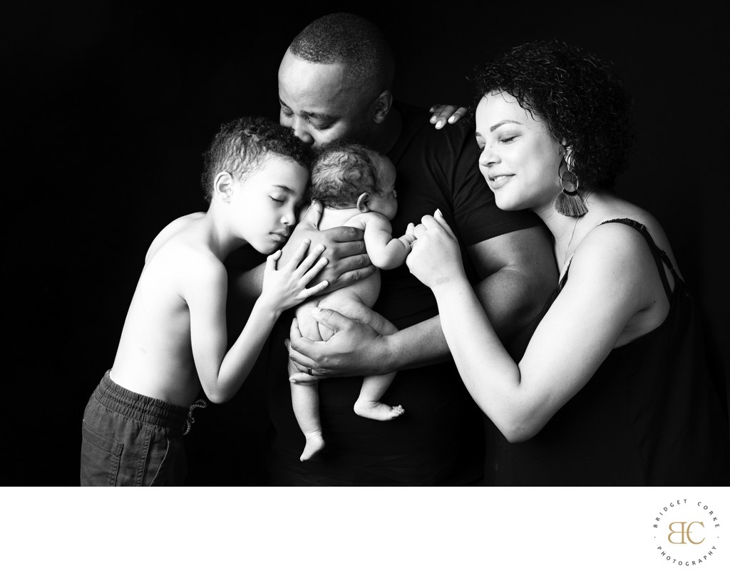 Family Embracing Newborn