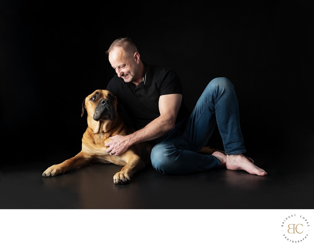 Bullmastiff and Man Seated