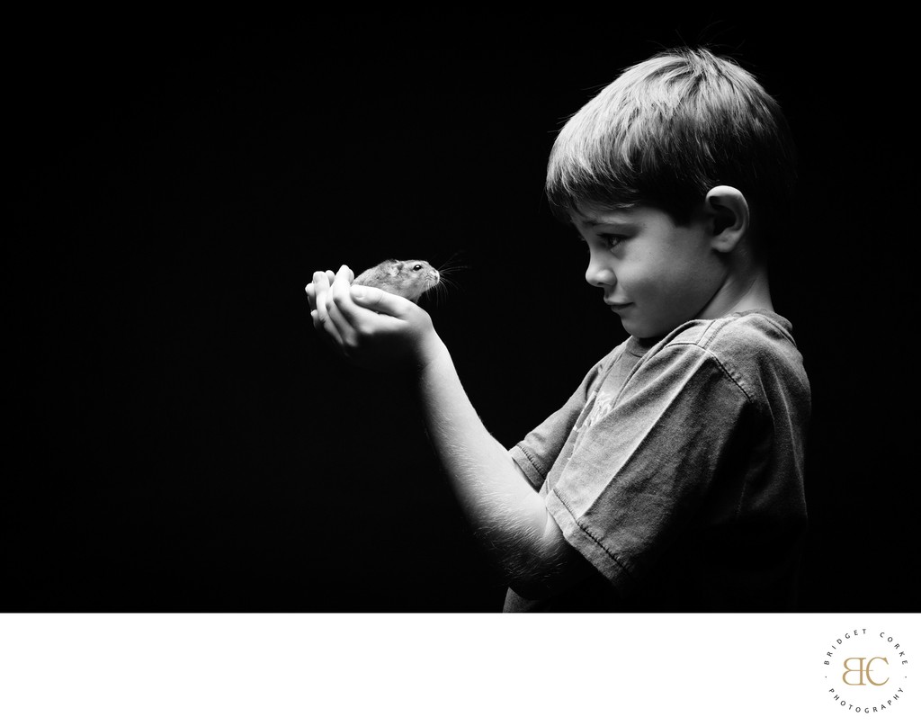 Young Boy Holding Pet Hamster