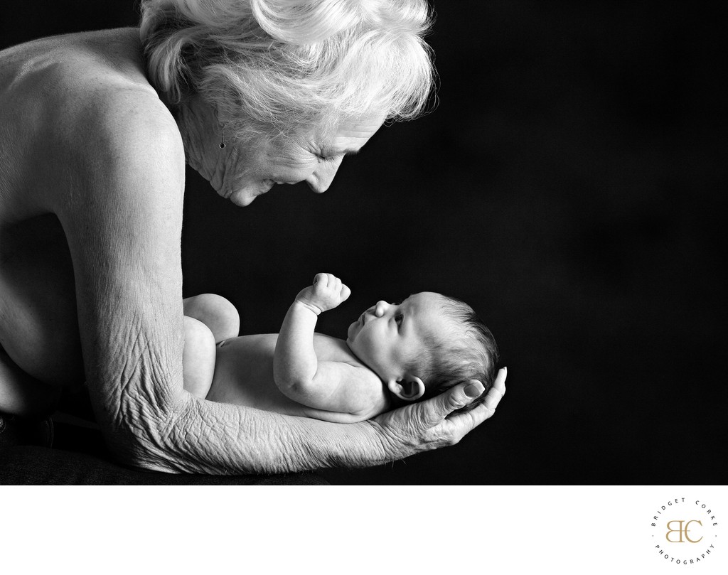 Timeless Touch: Grandmother Holding Newborn Baby