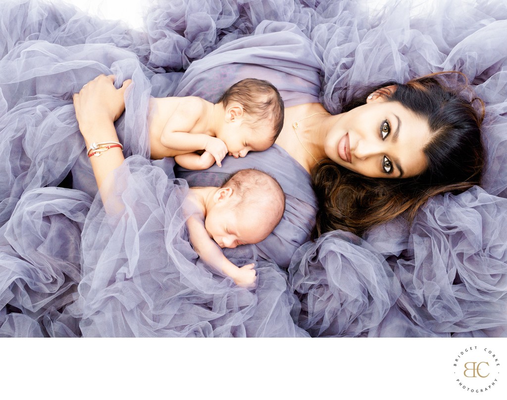 Twins Embrace: Mother & Newborns in Purple Tulle