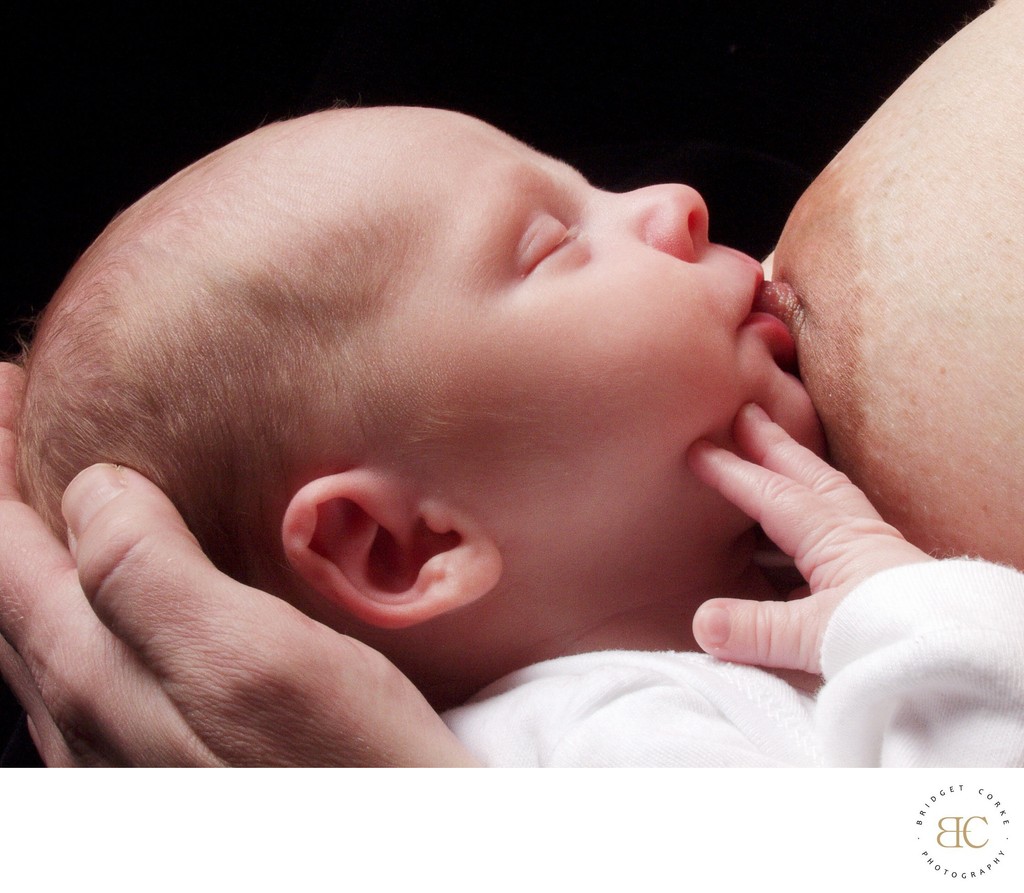 Serene Newborn Feeding Moment in Parent's Embrace