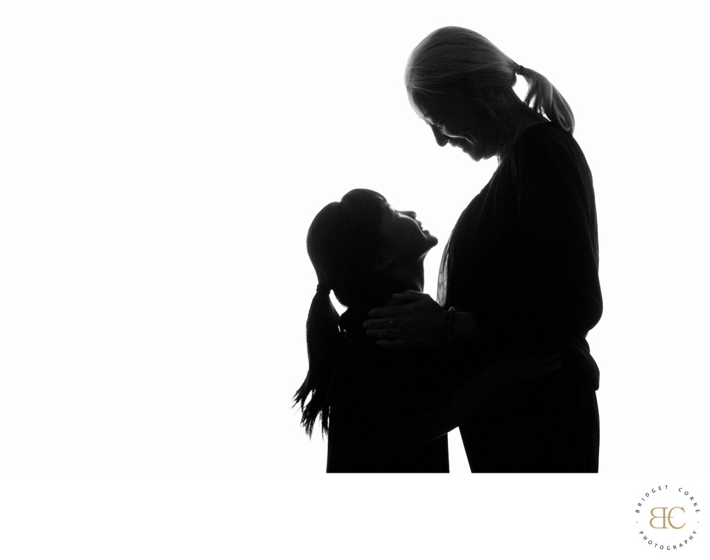 Grandmother and Grandaughter Silhouette Embrace