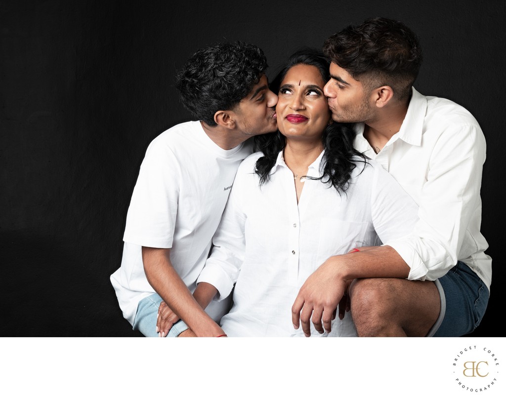 Mother with Sons Sharing Tender Moments in White