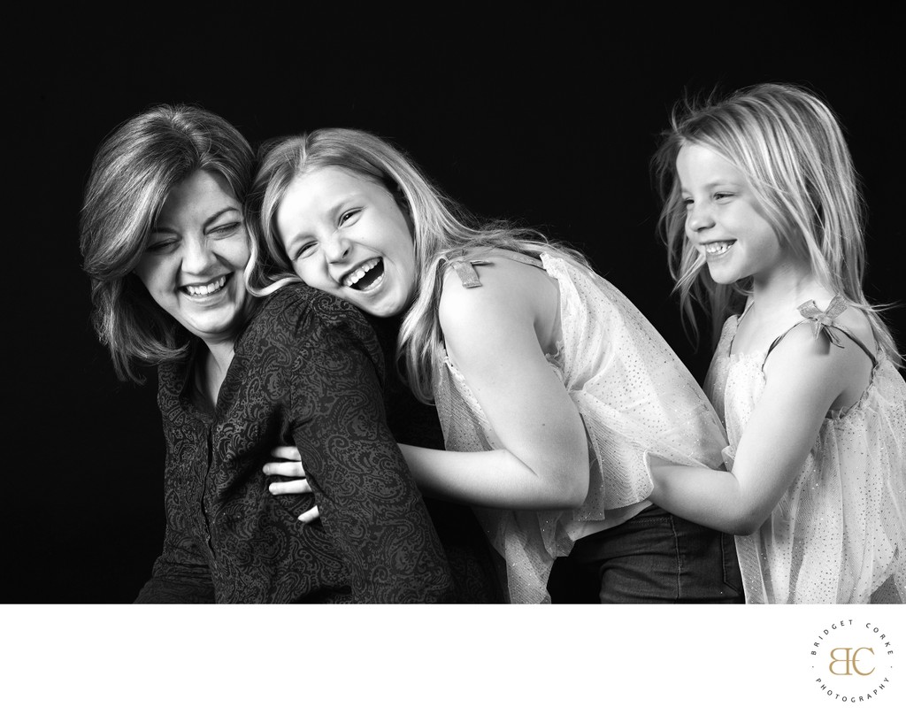 Playful Mother and Daughters Black-and-White Portrait