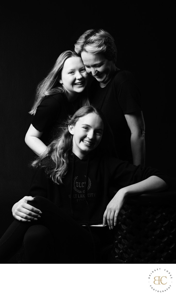 Joyful Mother and Daughters Black-and-White Portrait