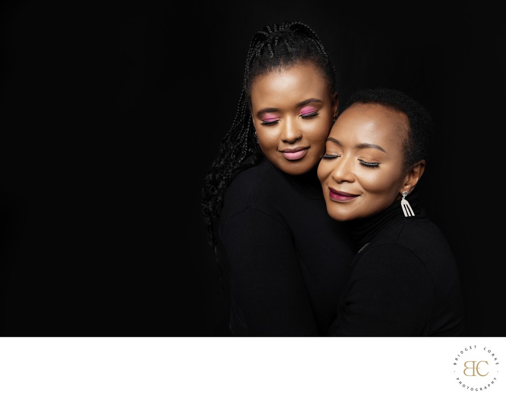 Elegant Mother and Daughter Embrace Portrait