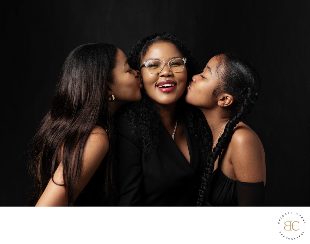 Playful Mother and Daughters Studio Portrait