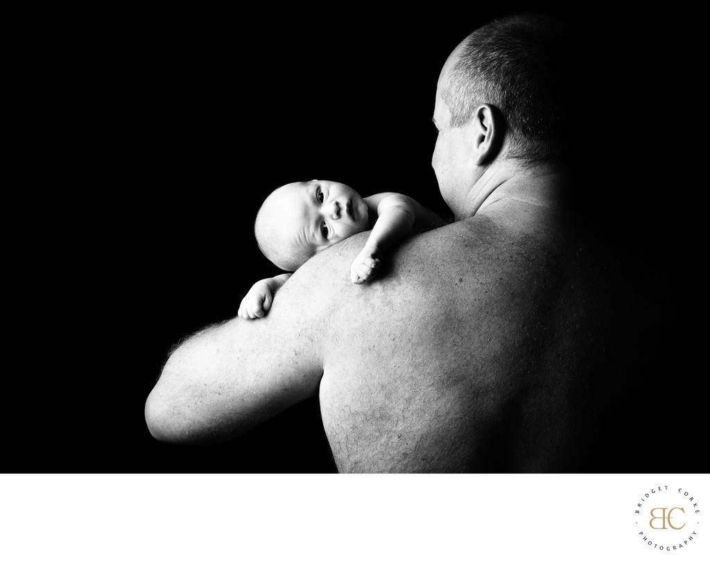 Tender Moment: Newborn Resting on Father's Shoulder