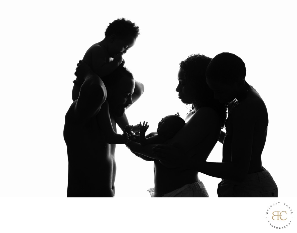 Family Silhouette: Embracing the Newborn