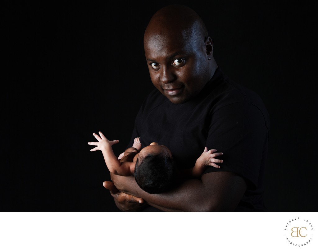 Proud Father: Holding Newborn with Care