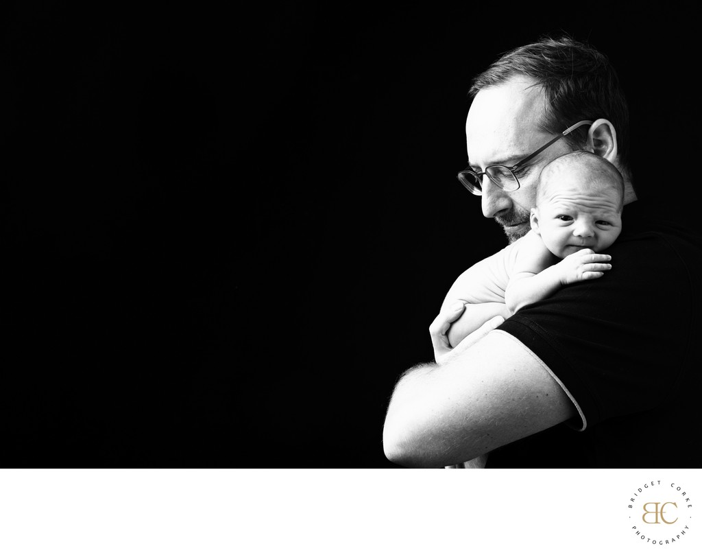 Father and Newborn Embrace Portrait