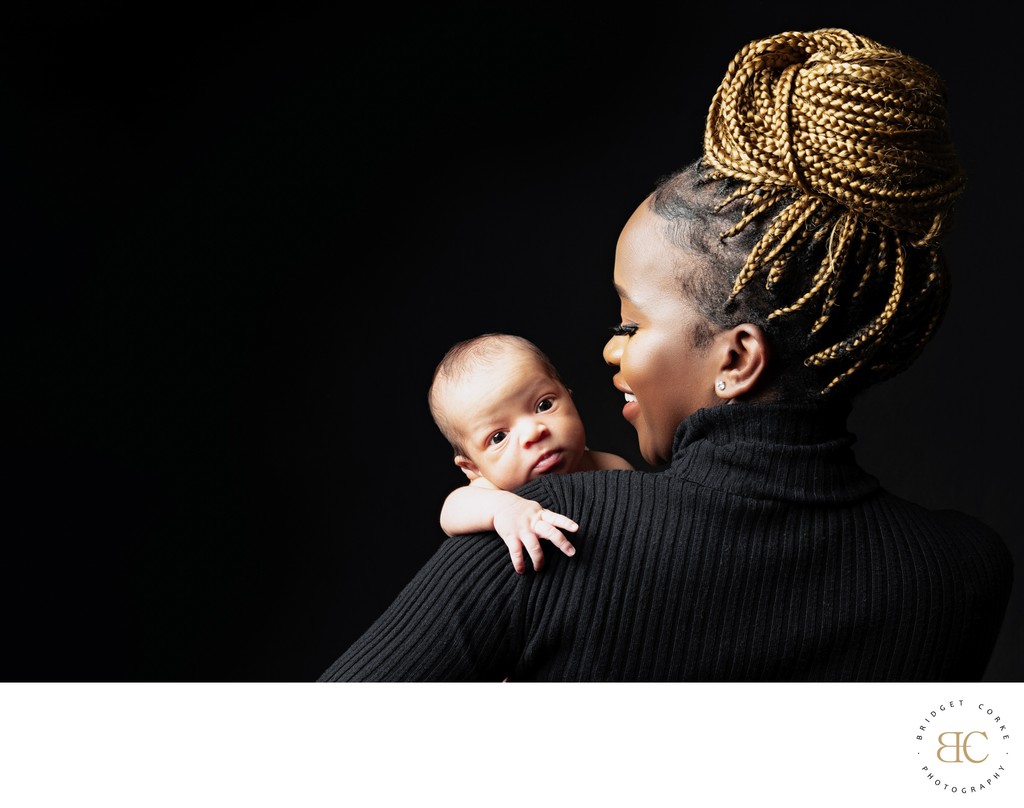 Mother’s Elegance: Newborn Over Her Shoulder