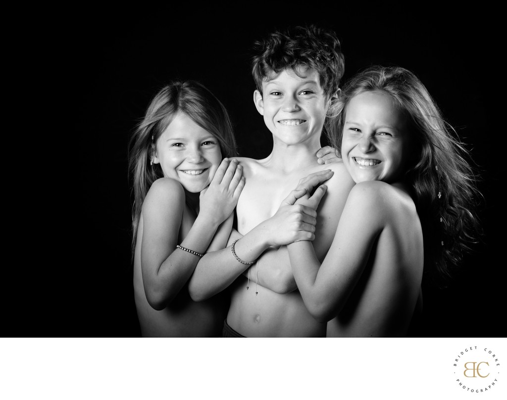 Joyful Trio: Award-Winning Portrait of Siblings